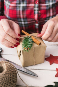 Woman wrapping cool christmas gift