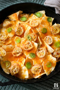 Everyone loves nachos. If you’re reading this recipe, you probably share our love of warm, cheesy, crunchy nachos. The more cheese the better, right? Since we’re all nacho enthusiasts around here, we thought it would be fitting (and delicious) to create an Asian-Mexican fusion nacho recipe using our egg rolls. Egg Roll Nachos are a tantalizing twist for a weeknight meal or a festive fiesta!